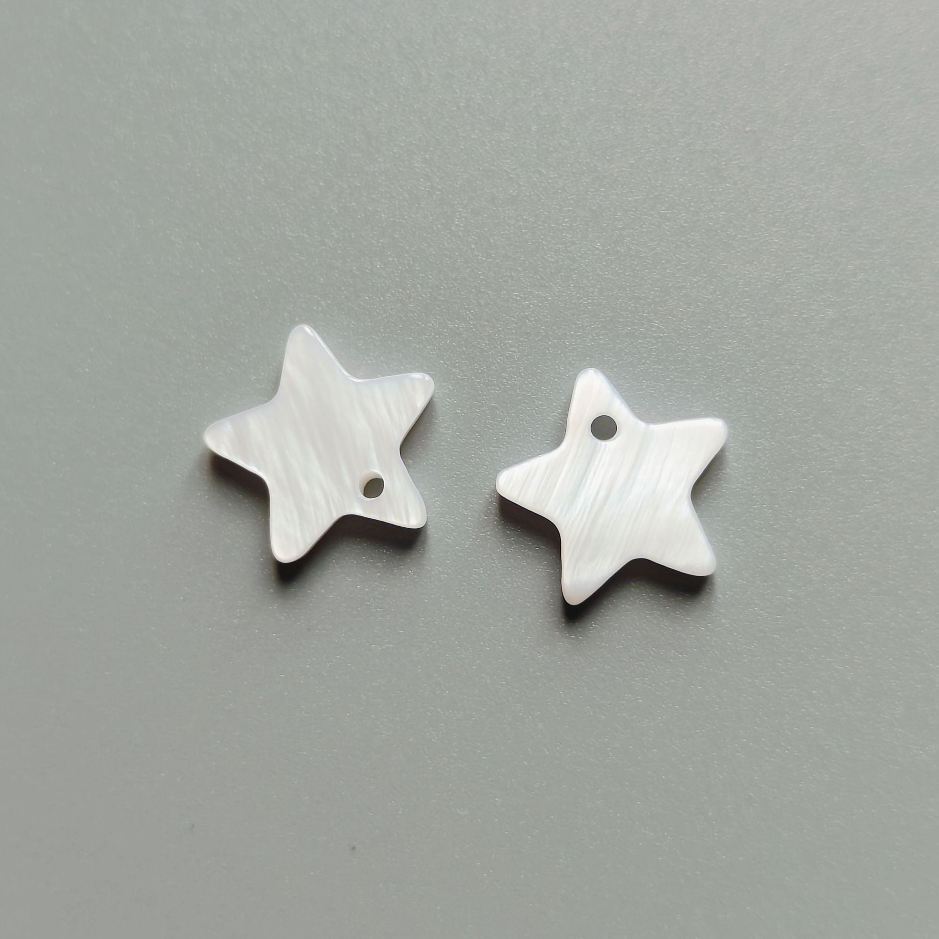 White star shell buttons, single-hole, two pieces shown