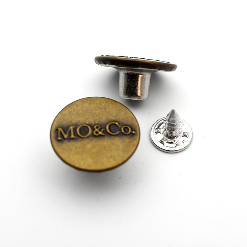 Round metal shank stud button with MO&Co logo, gold-toned front