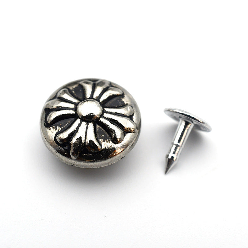Round metal shank stud button with daisy/sunburst floral pattern