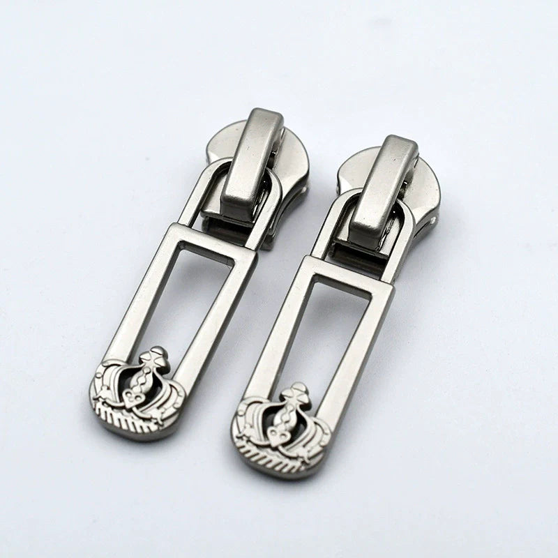 Silver-tone metal zipper pulls with open frame bar and small crest graphic, 10-pack