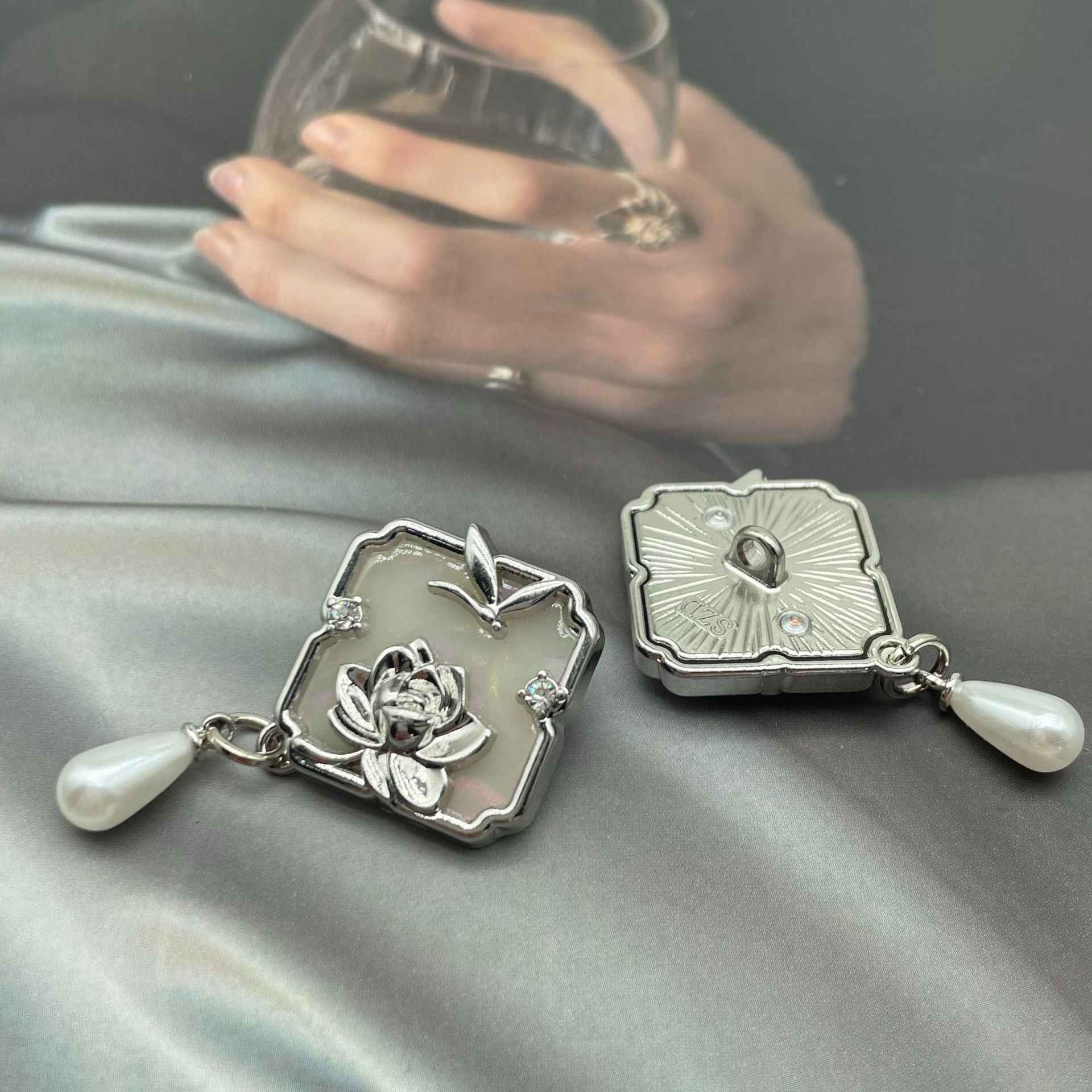 Silver 1-inch metal sew-on button pair with lotus and dragonfly motifs, crystal accents