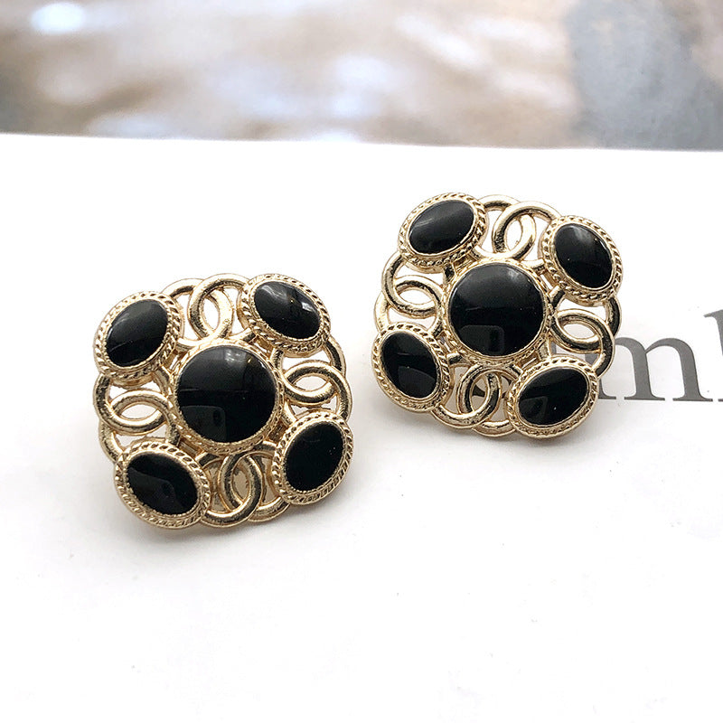Square metal shank pearl buttons with dark black round pearl centers, gold-tone frame