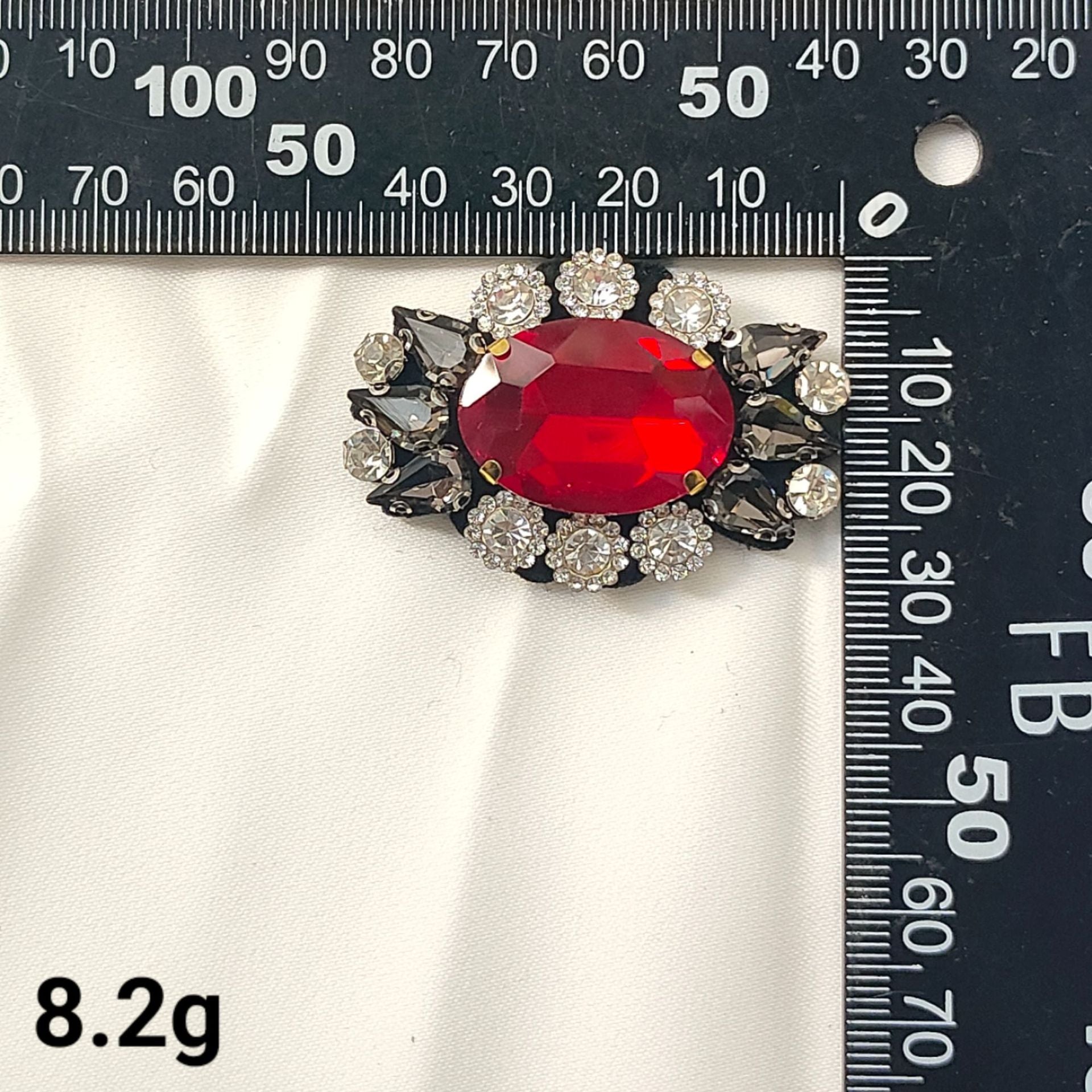 Red oval crystal flower patch with dark beaded accents and silver rhinestones