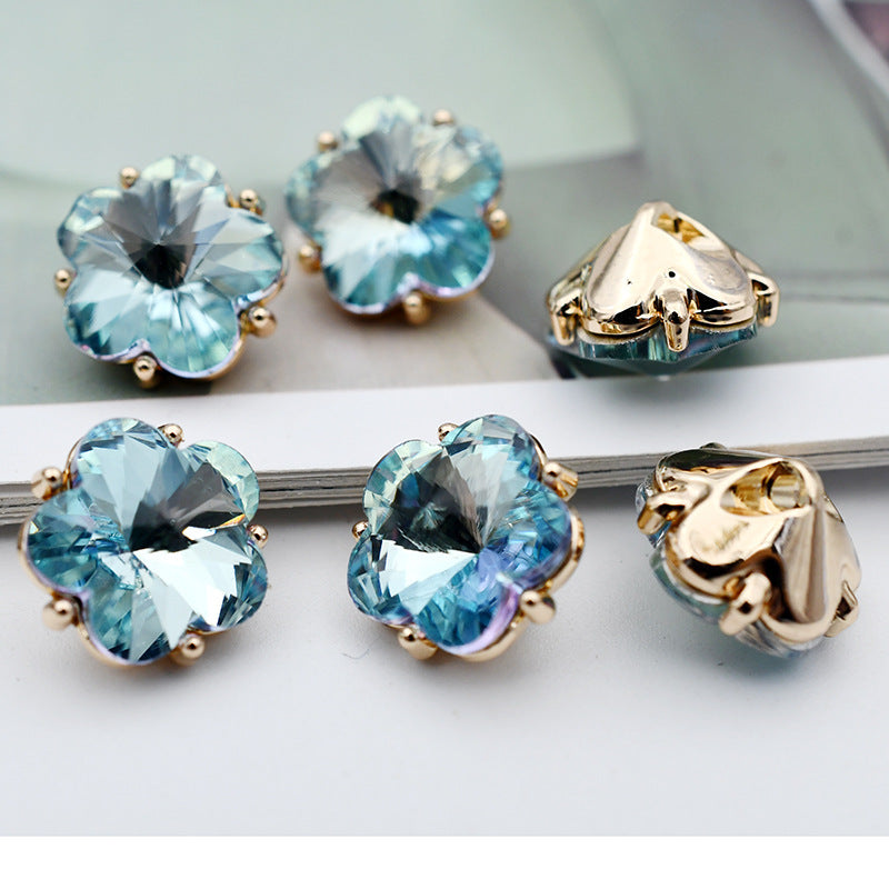 Small flower glass rhinestone shank buttons, sky blue flower faces with gold-tone settings and metal shanks