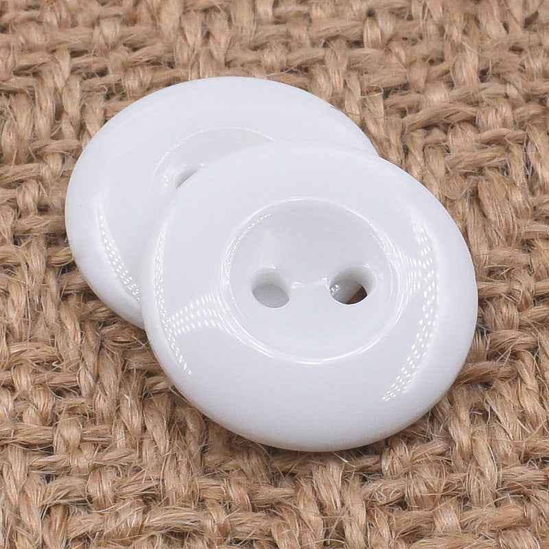 Round white 2-hole resin button, front view with two holes and glossy ring around