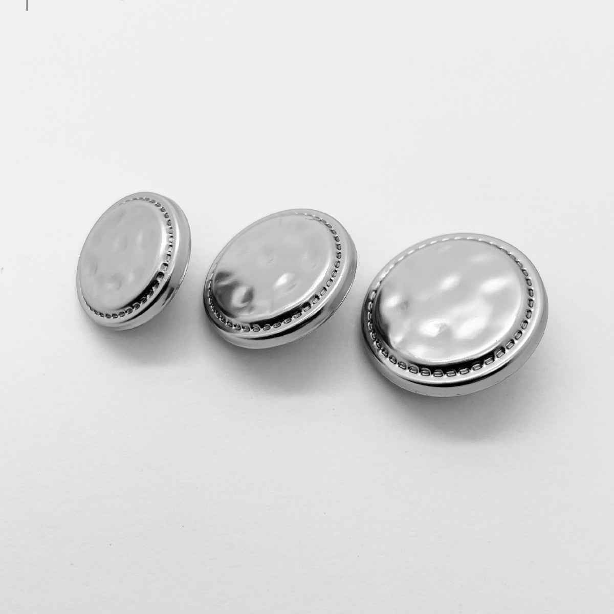 Light silver metal press studs, multiple round snap buttons