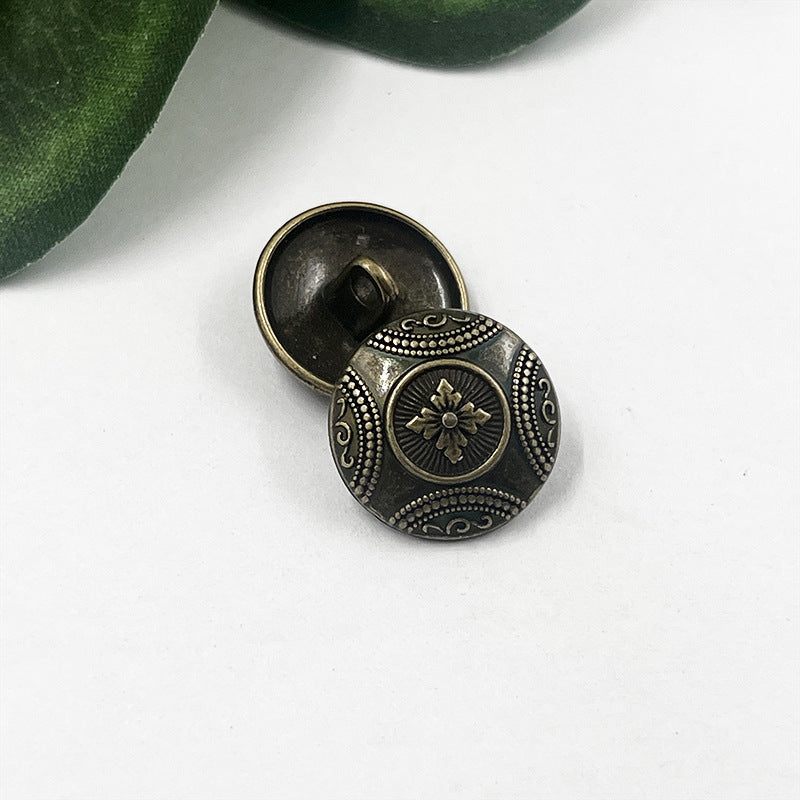 Antique bronze flower metal shank button, round face with central bloom motif