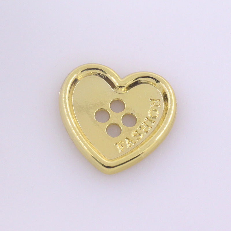 Heart-shaped metal button with four holes, shiny gold finish