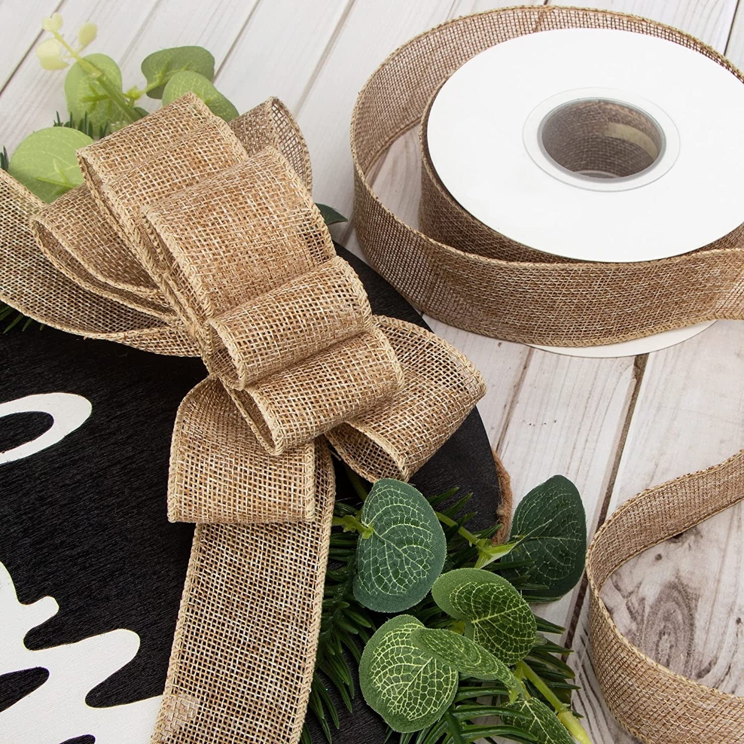 Beige cotton ribbon roll and stacked bow on a wreath-style decoration