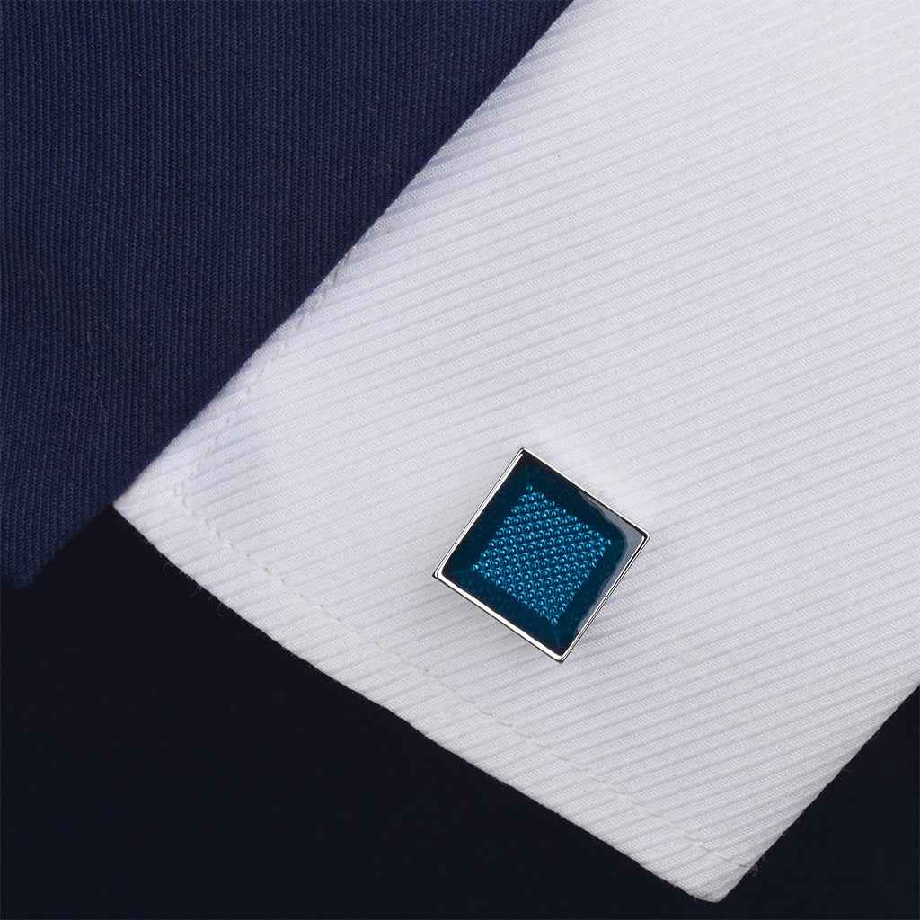 Blue resin square cufflink with silver border on white shirt cuff