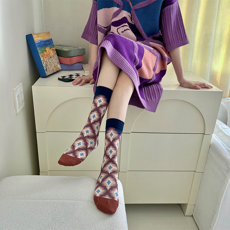 Woman wearing Monet-style cotton socks: purple and dark geometric pattern with matching toe detail