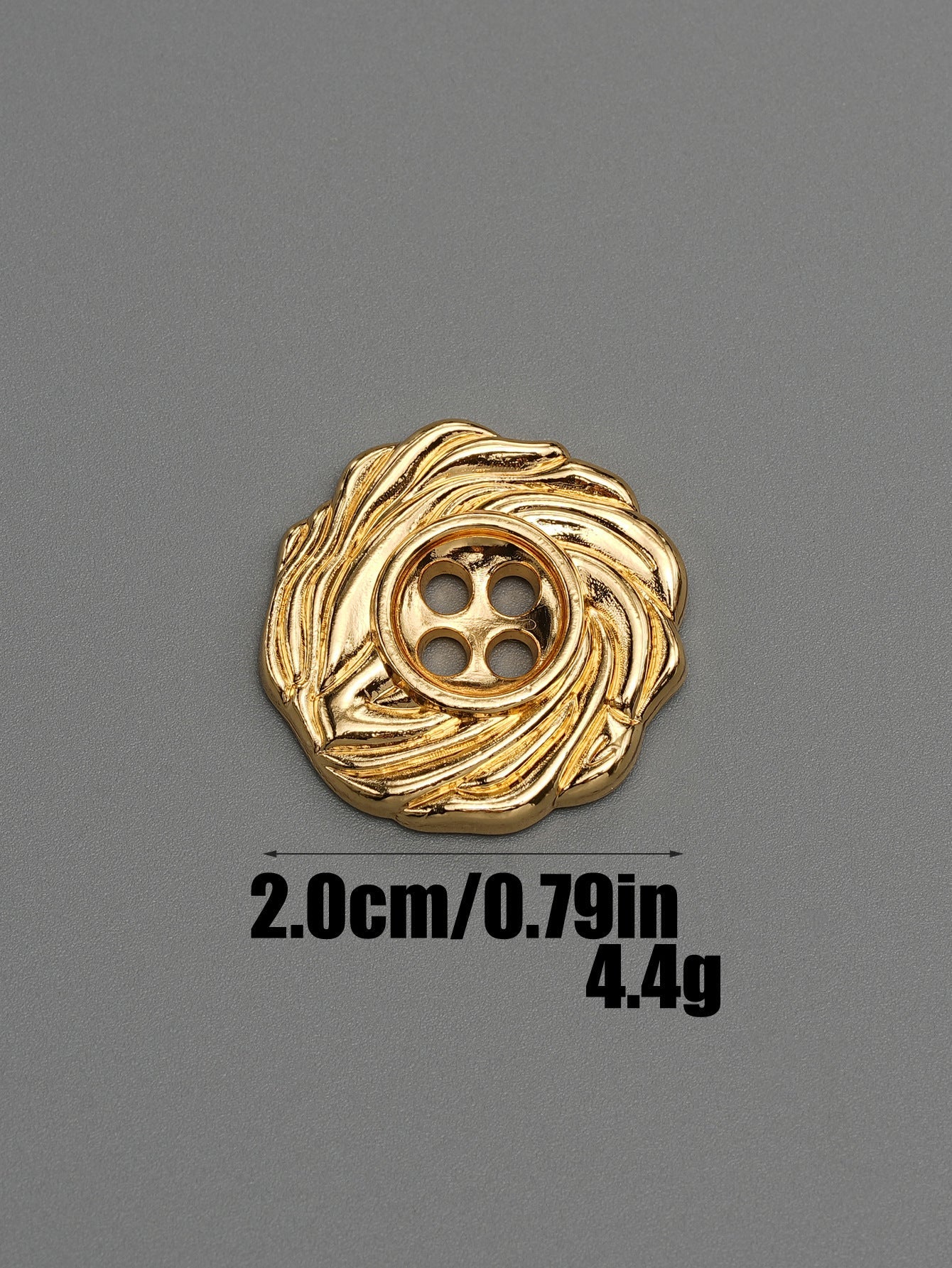 Gold tone 4-hole spiral metal button with textured swirl pattern, front view