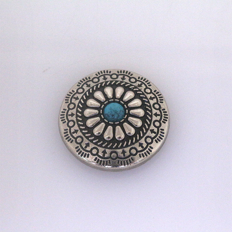 Turquoise metal stud button with central blue stone and sunburst filigree