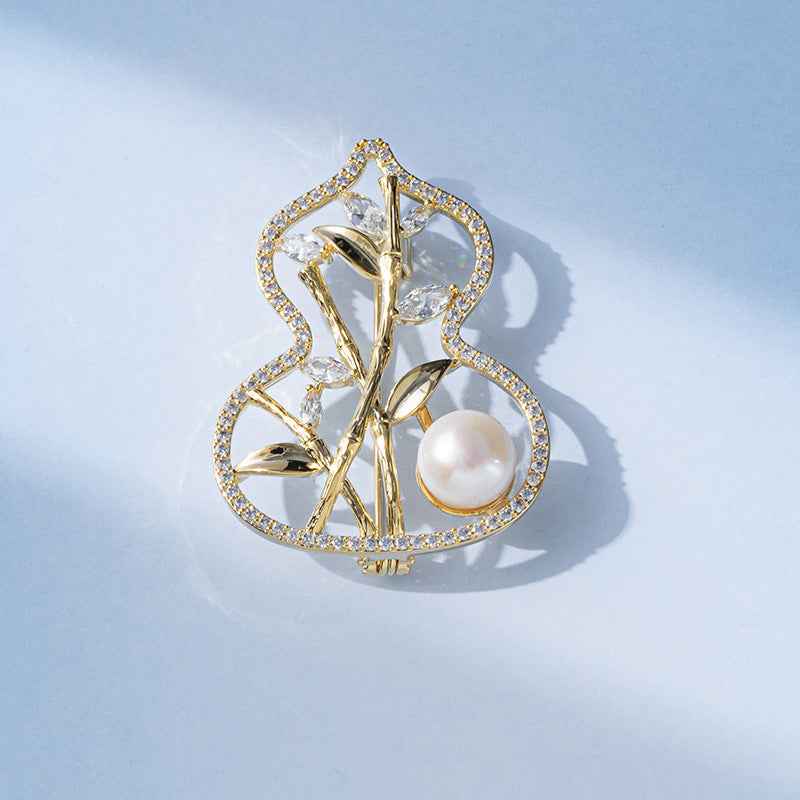 Copper-tone bamboo gourd brooch with white freshwater pearl and crystal-like stones