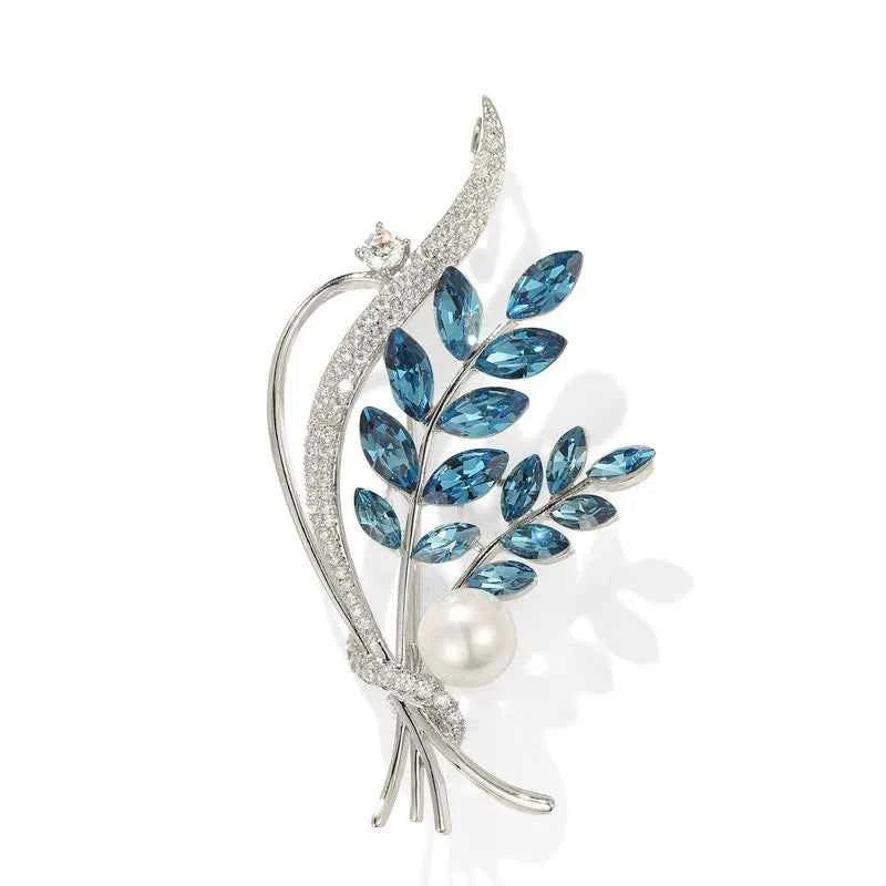 Floral bouquet brooch with silver-tone setting, blue crystals and white freshwater pearl.