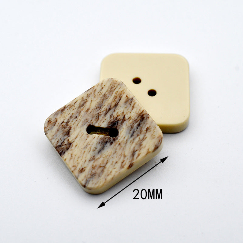 Square beige marble resin button with black-styled 2-hole center; size 20mm