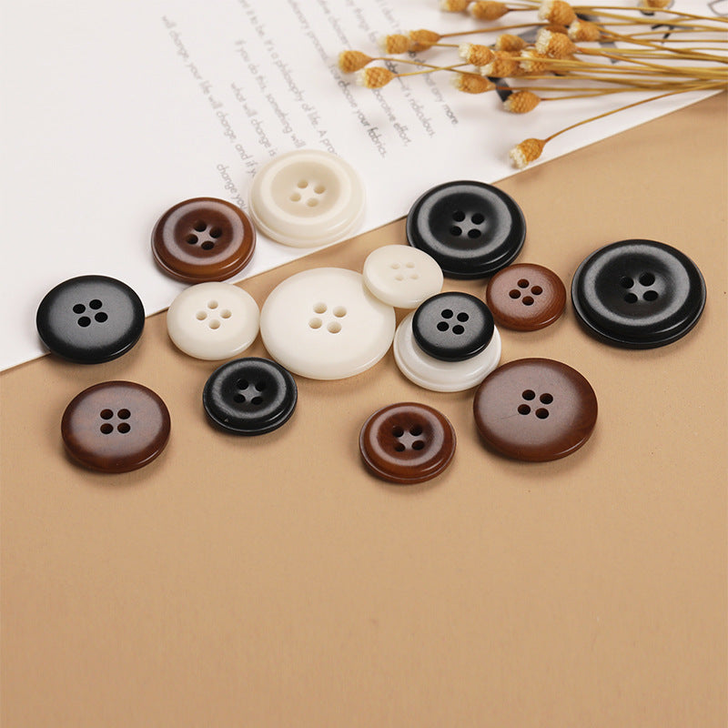 Mixed round 4-hole natural fruit shell buttons in black, brown, and off-white