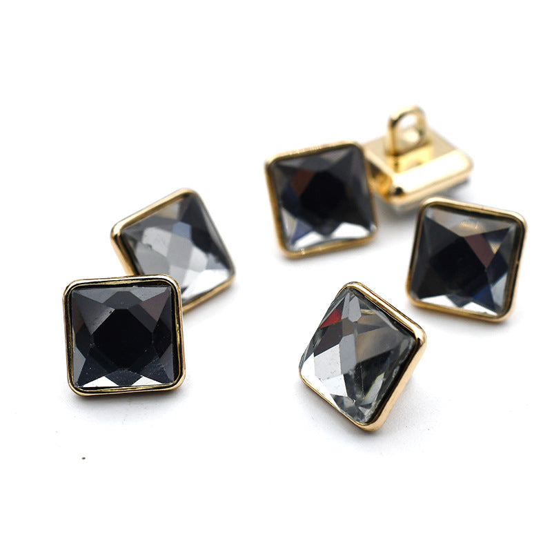Square glass cuff buttons with dark and black tones, gold metal settings and metal shanks