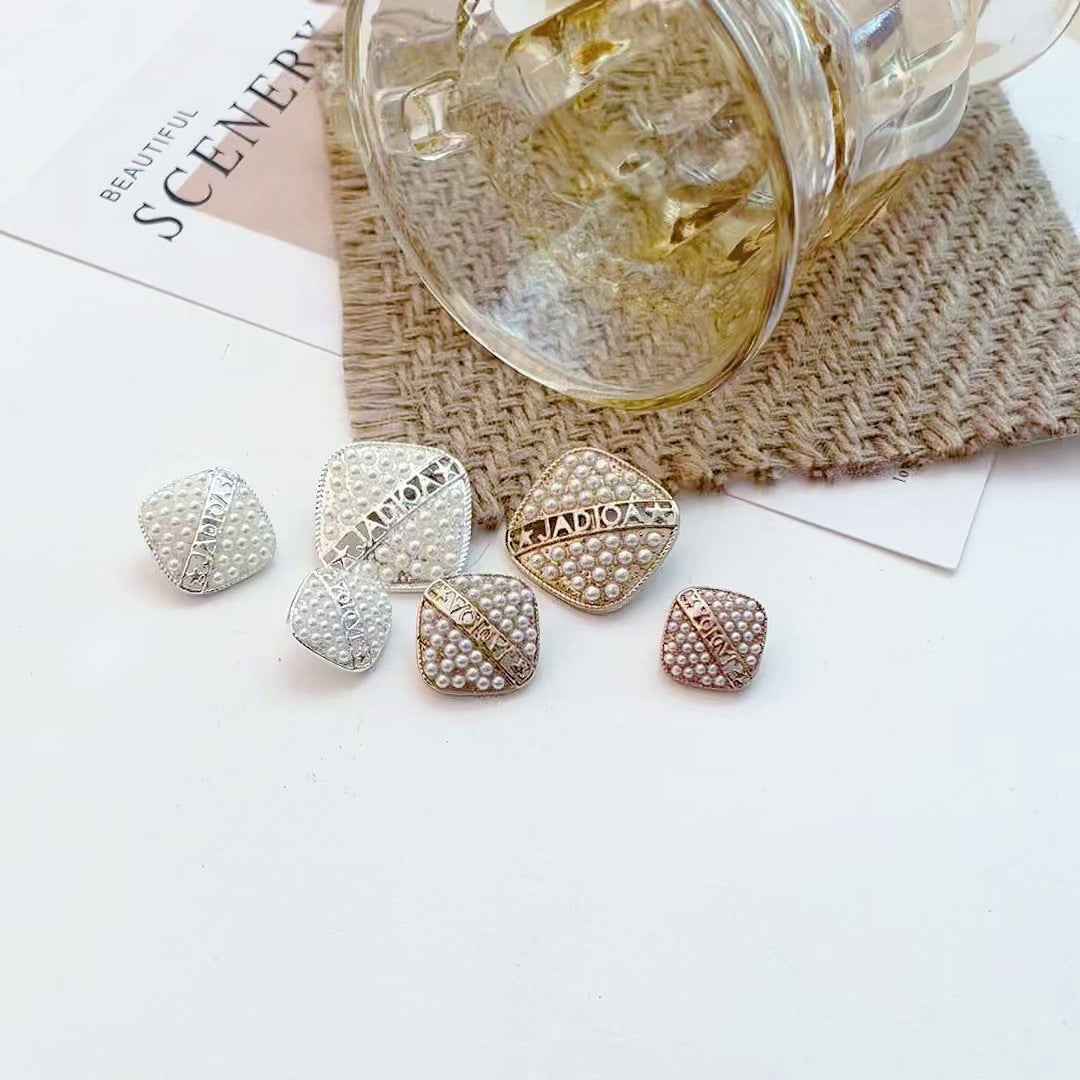 Assorted gold and silver square pearl-look metal buttons with geometric center
