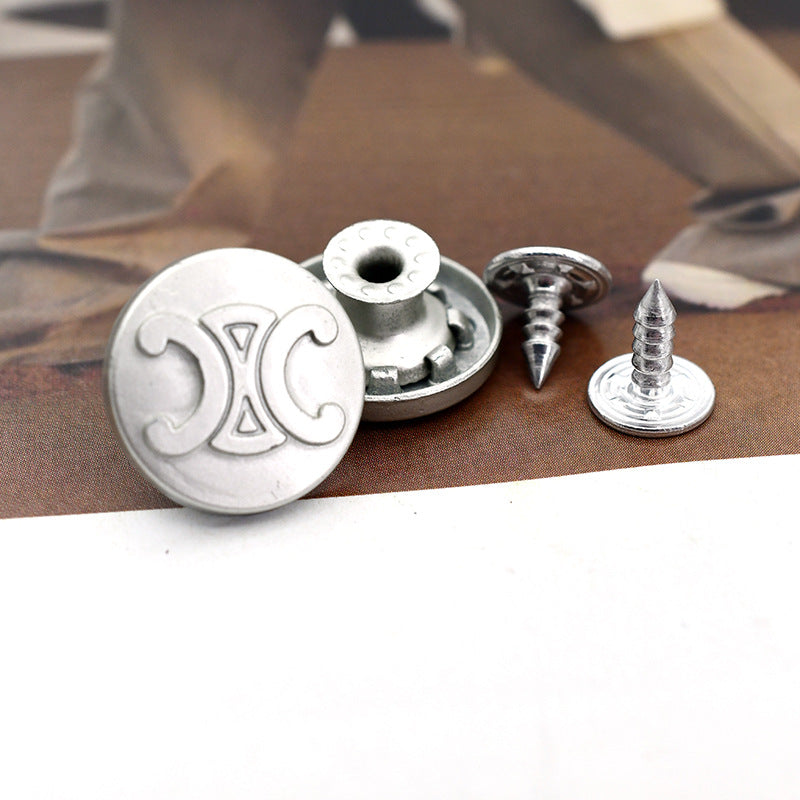 Metal shank stud buttons with pointed screws on denim fabric