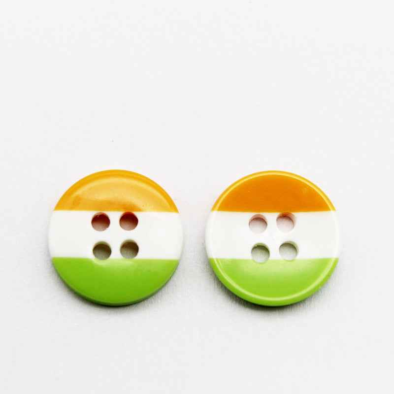 Round resin button with golden yellow top, white middle, and green bottom stripes; four holes.