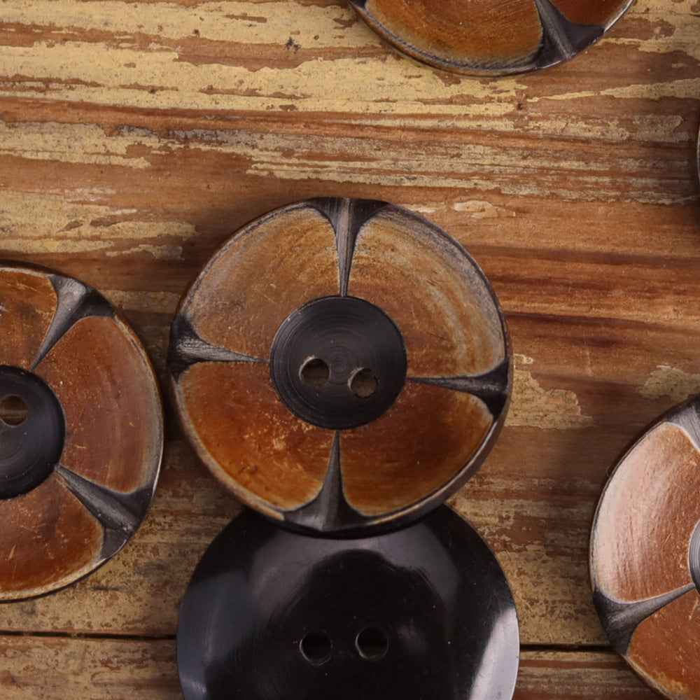 Two-tone 2-hole horn buttons with carved floral petal design and dark center