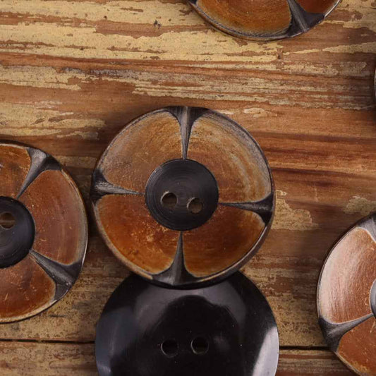 Two-tone 2-hole horn buttons with carved floral petal design and dark center