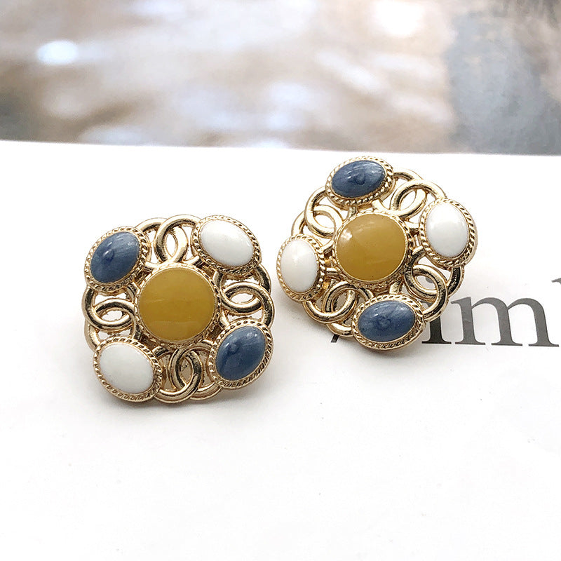 Square metal shank pearl buttons with yellow center, navy blue edge pearls, white accents