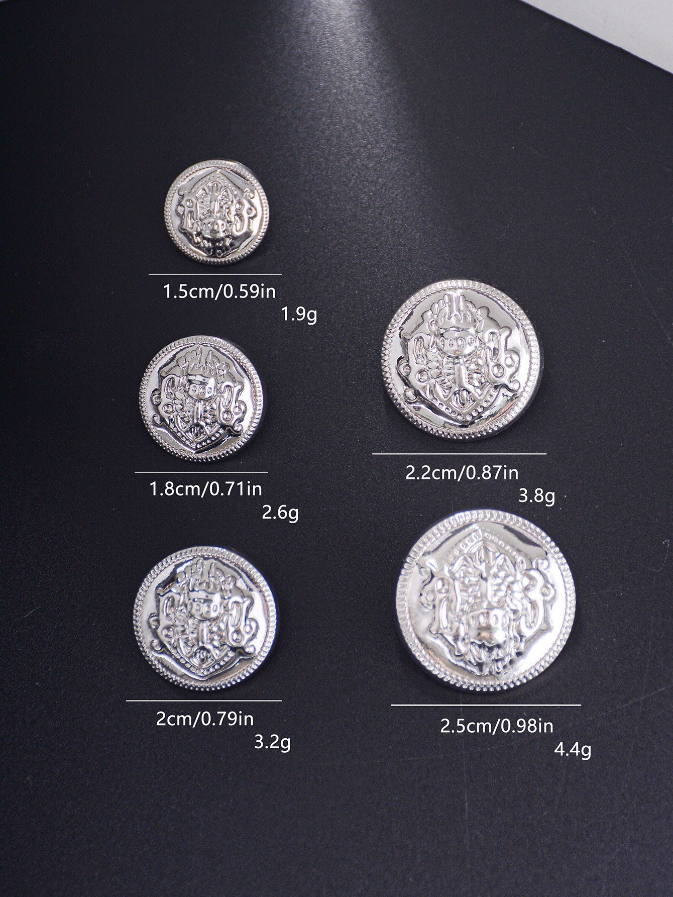 Silver-tone embossed decorative shank buttons, crest medallion pattern, mixed sizes.