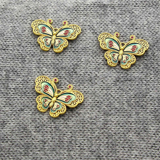 Copper butterfly button with teal and red enamel wings, ornate gold filigree, 2 holes.