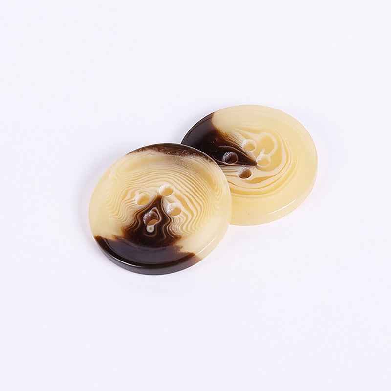 Round resin buttons, four-hole, yellow front with visible holes and swirl design