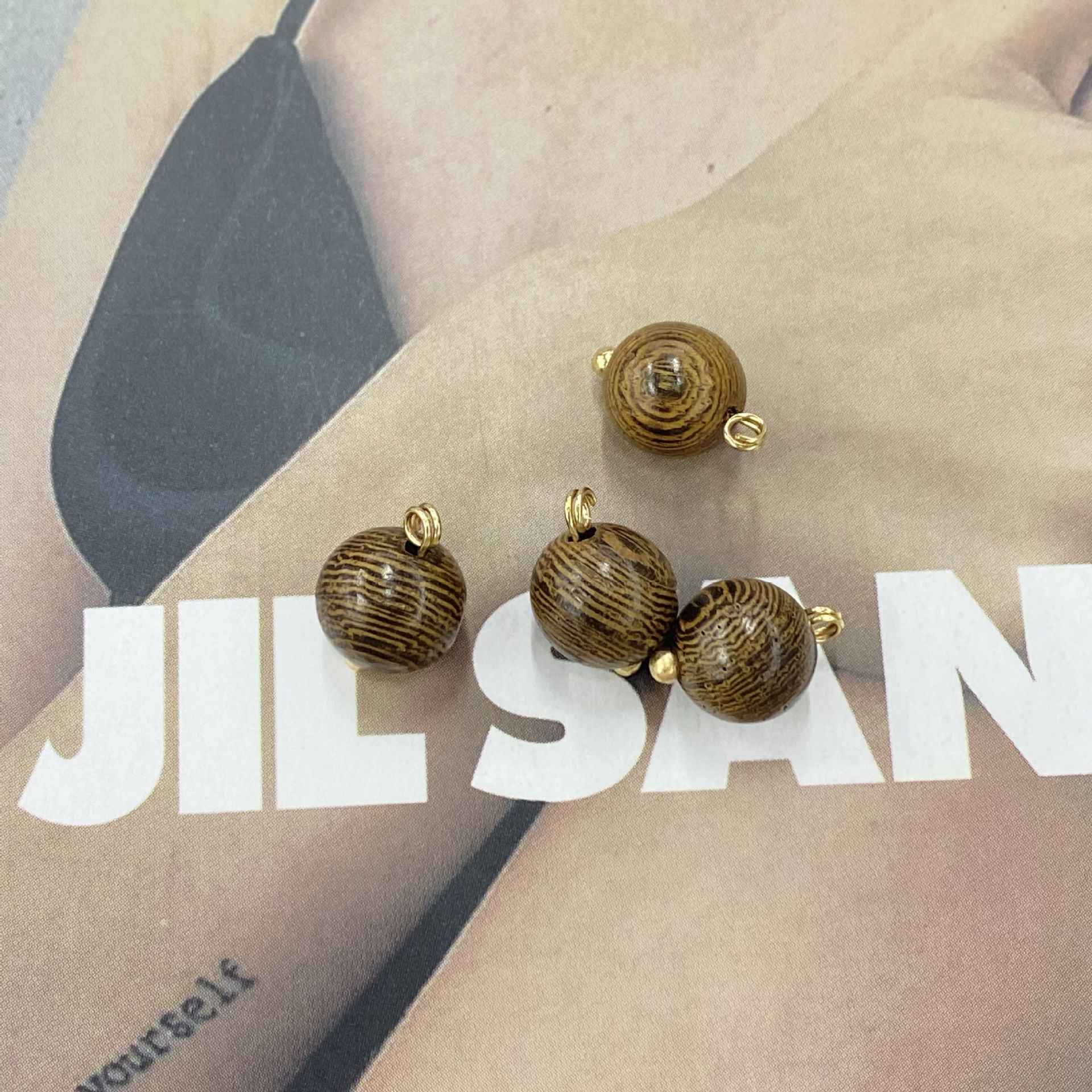 Dark coffee striped round wooden buttons with gold-tone loops