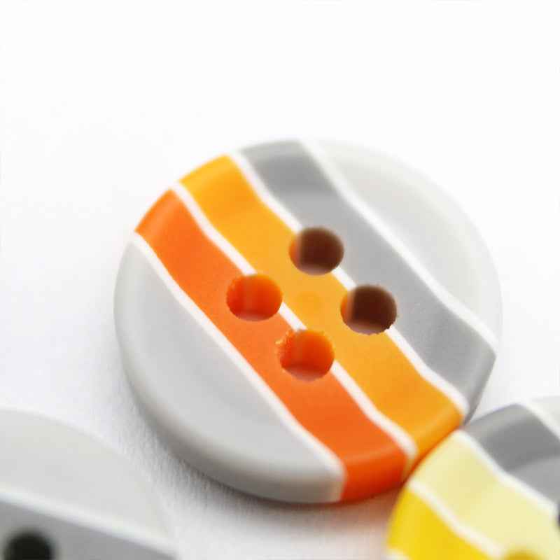 Round resin button with orange and white striped design, brown buttonholes, four holes
