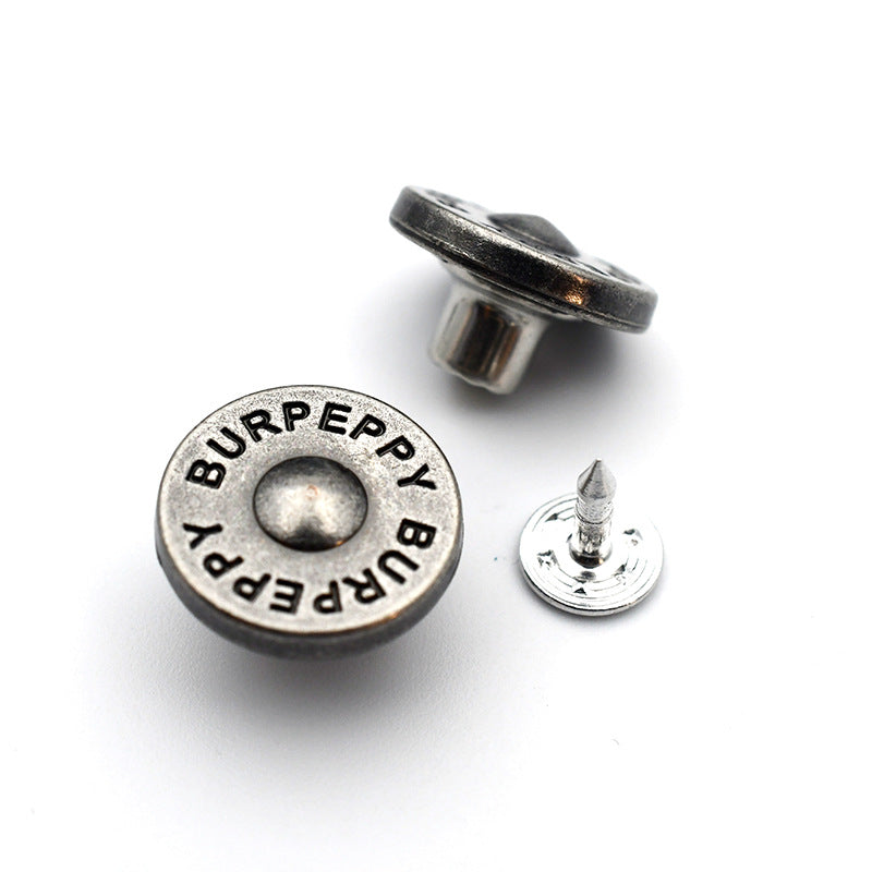 Round metal shank stud button with “BURPEPPY BIPPER” logo text front and pointed post