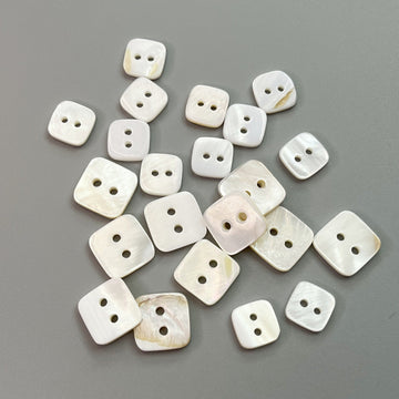 Square natural shell shirt buttons with two holes, off-white set of small buttons.
