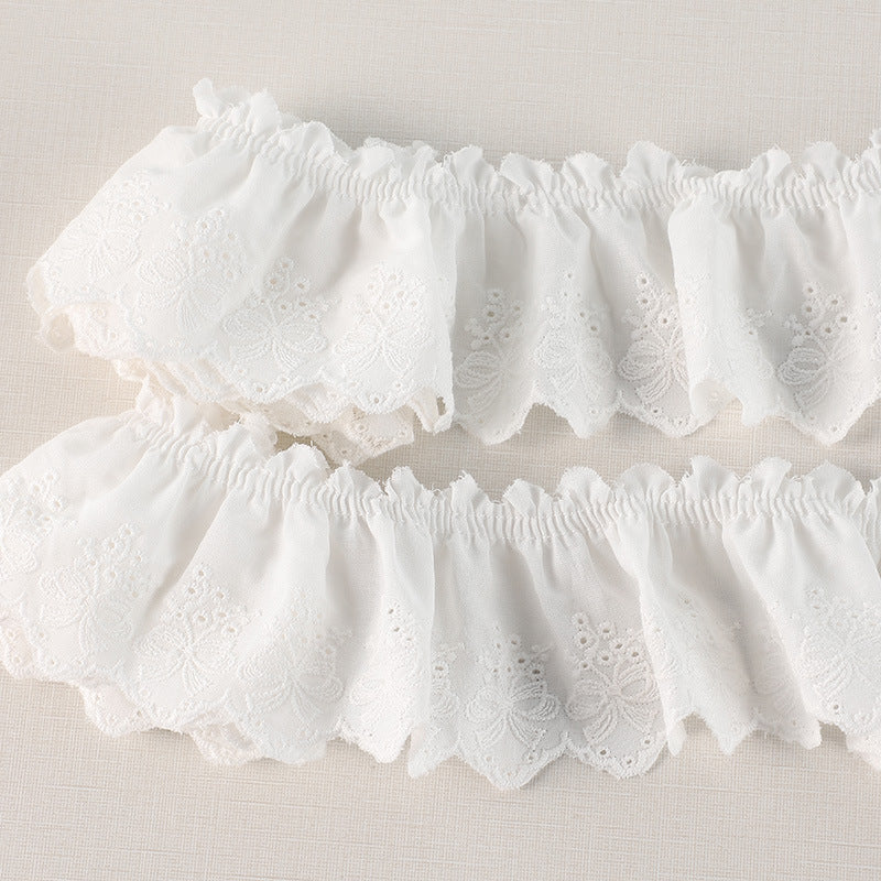 Off-white pleated lace trim with butterfly embroidery, layered ruffle panels and scallops