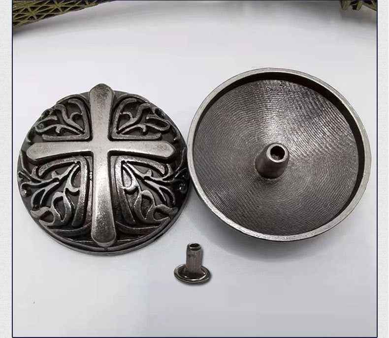 Floral cross rivet with detailed antique carving; reverse round back with mounting post