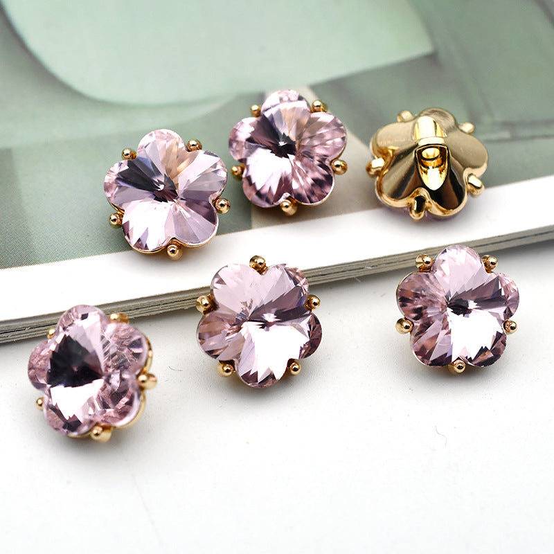 Small flower glass rhinestone shank buttons, light pink flower faces with gold-tone settings and metal shanks
