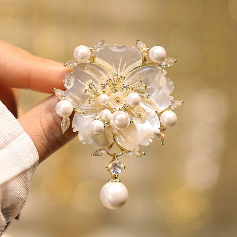 Camellia shell pearl brooch, layered petals with white pearls, gold-tone frame, zirconia