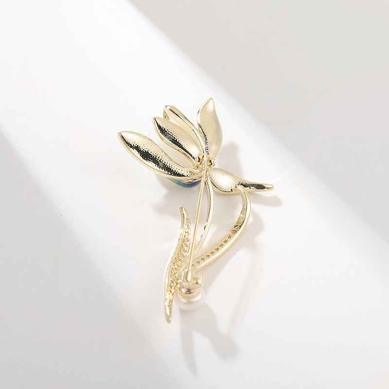 Magnolia brooch pin, enamel flower design with gold-tone setting and hinged clasp