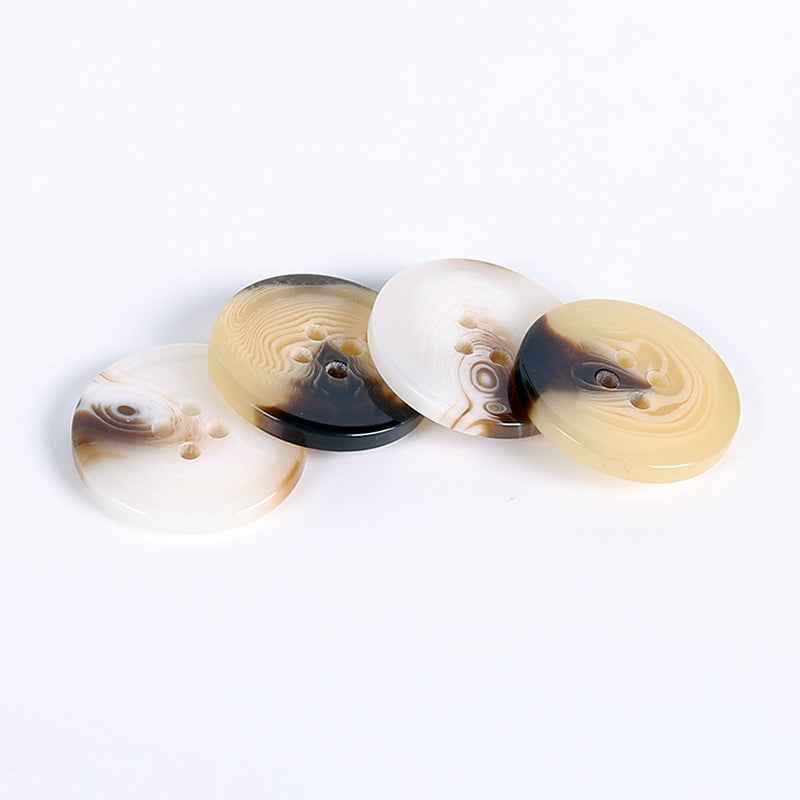 Round resin buttons, four-hole, white and yellow colors with swirl pattern