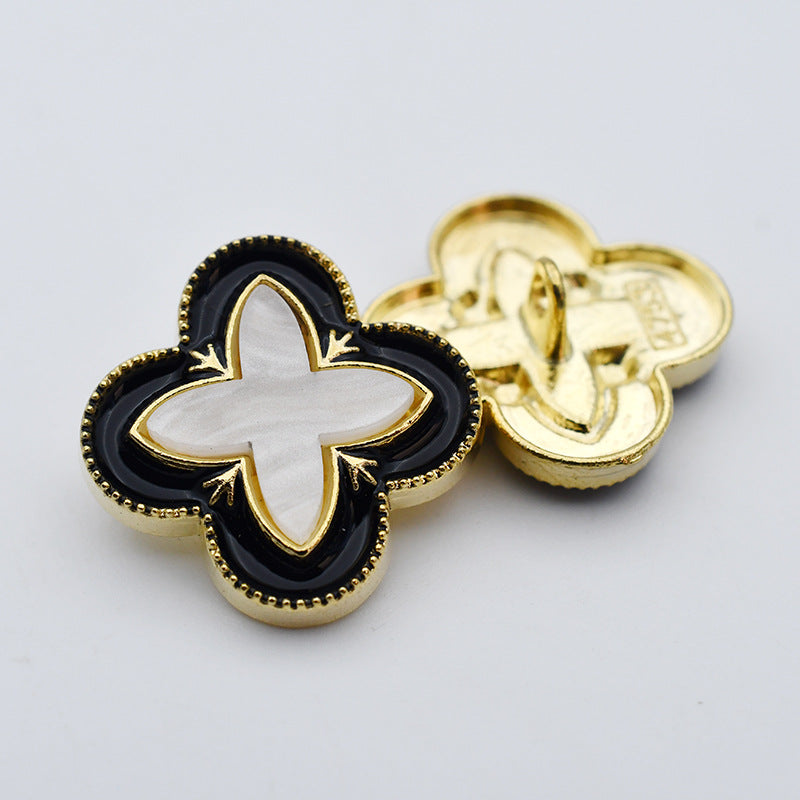 Four-leaf clover shank buttons, black enamel with gold trim and white center