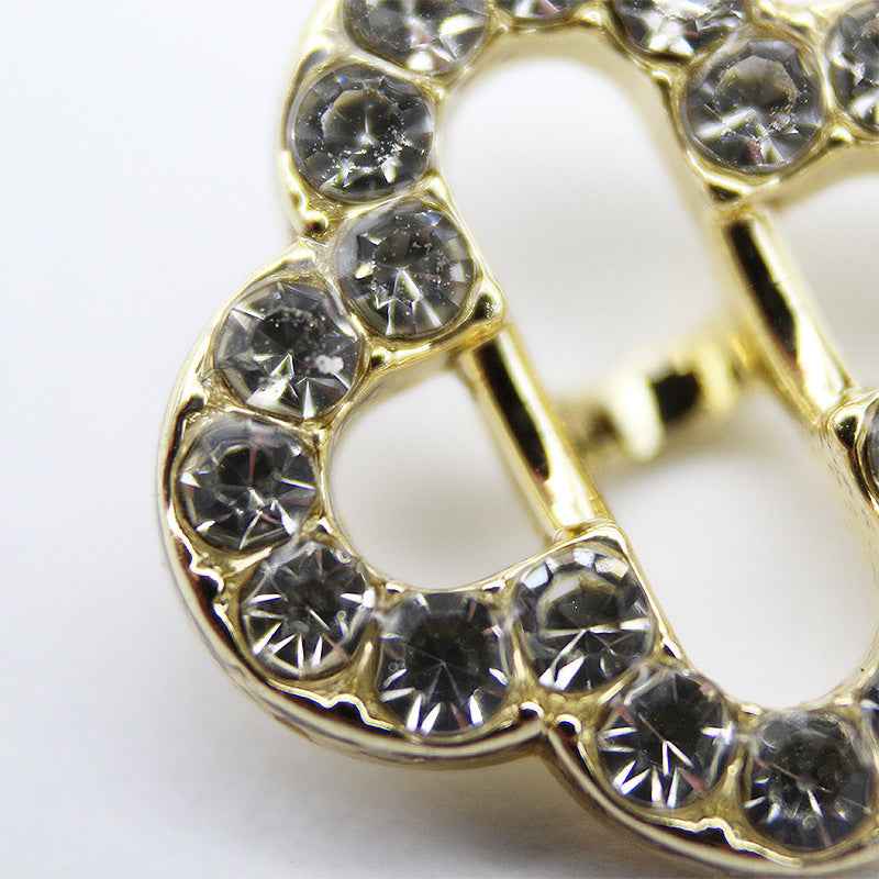 Gold-tone four-leaf clover rhinestone shank button with detailed crystal border