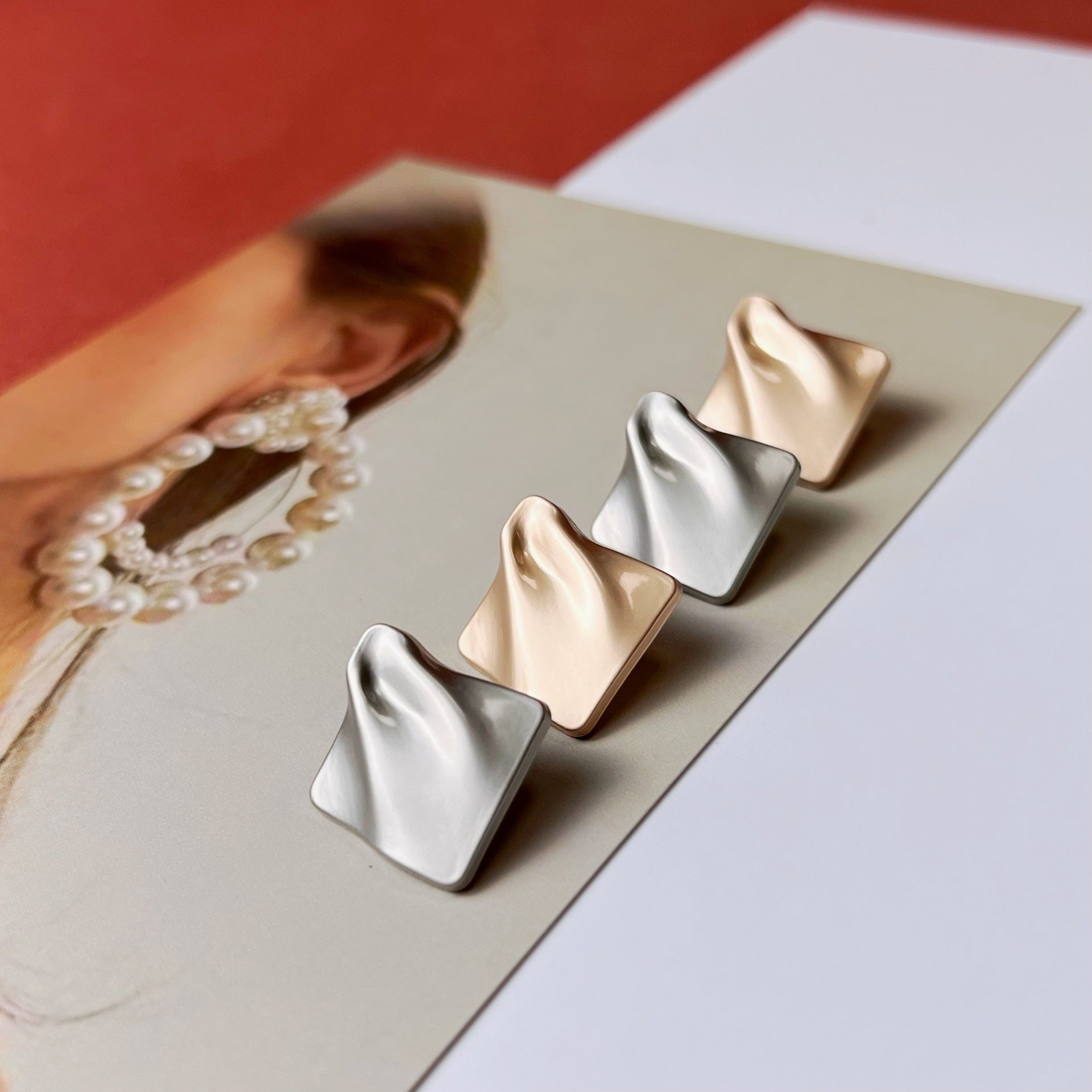 Diamond-textured metal shank buttons in gold and nickel, angled view