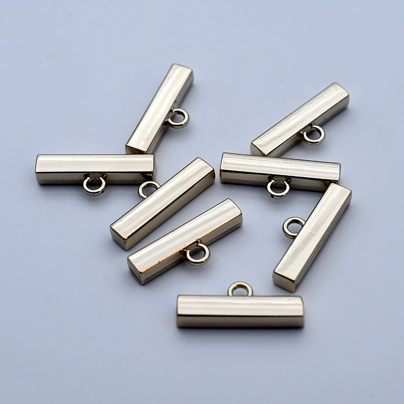 Metal bar buttons in gold finish, rectangular shape with circular loops on top
