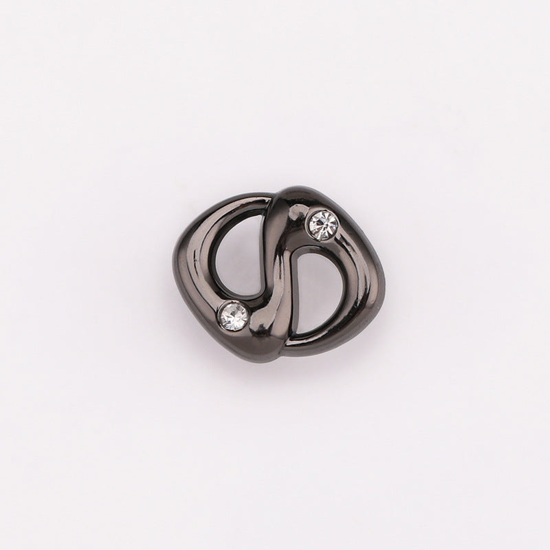 Gunmetal pig-nose rhinestone shank button with two clear stones and a curved metal frame