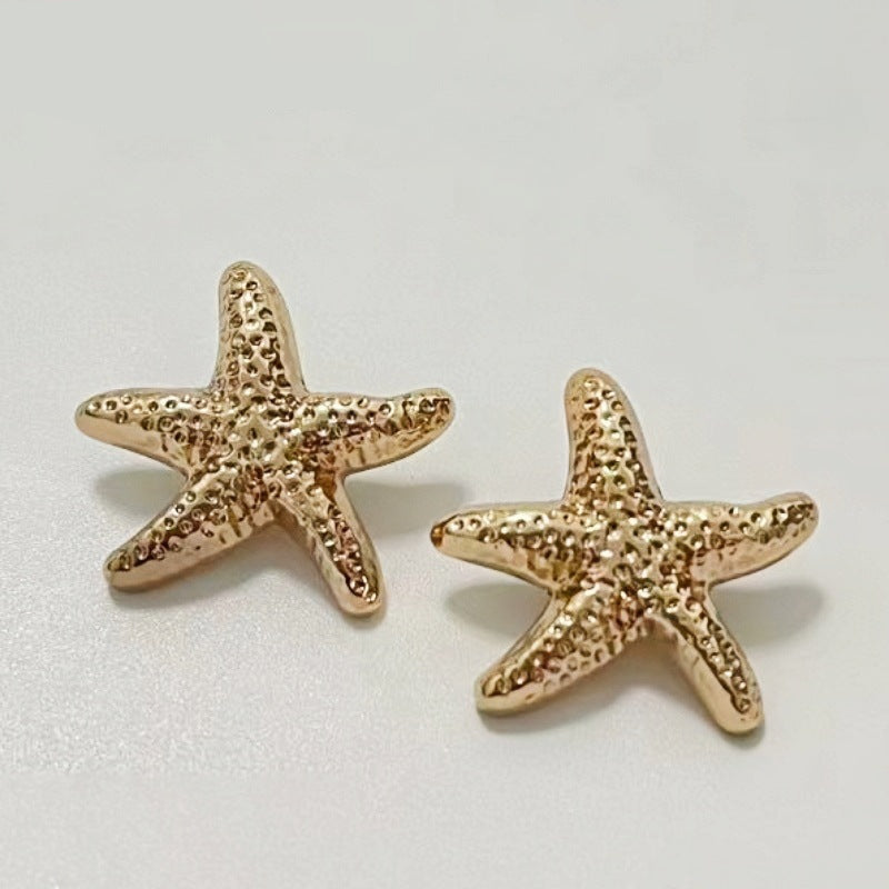 Gold starfish metal shank buttons, two sea-star designs with textured texture