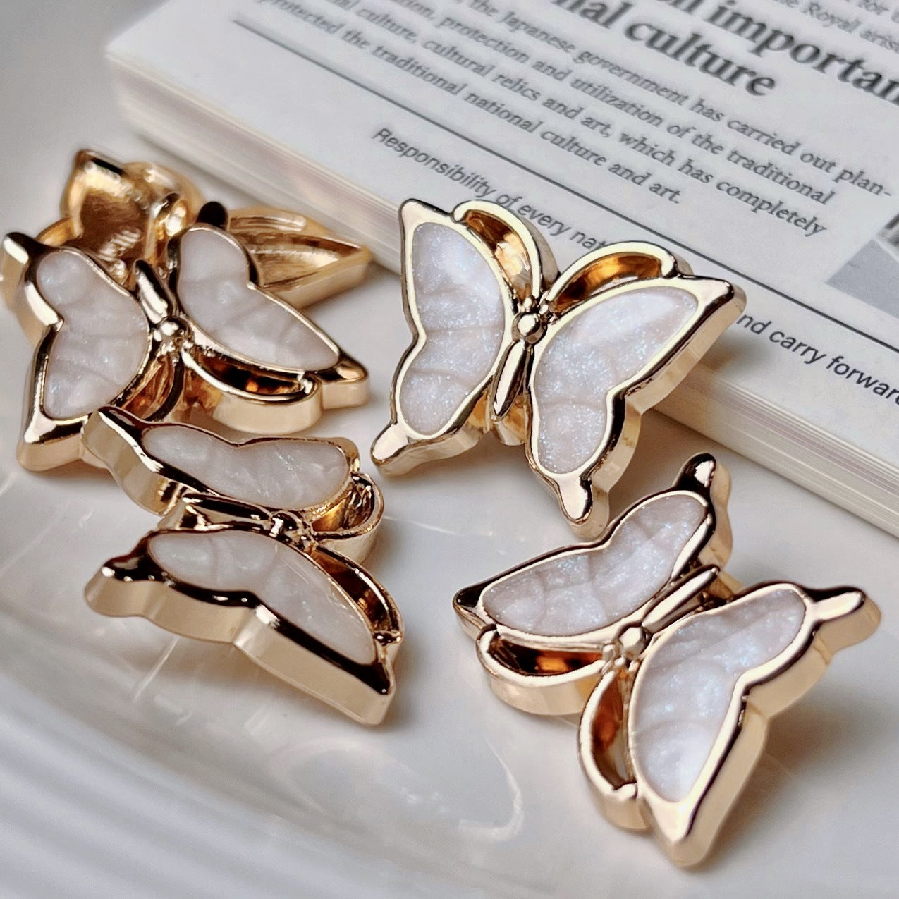 Light pink 3D butterfly buttons, pearl white wings, gold-tone metal shanks