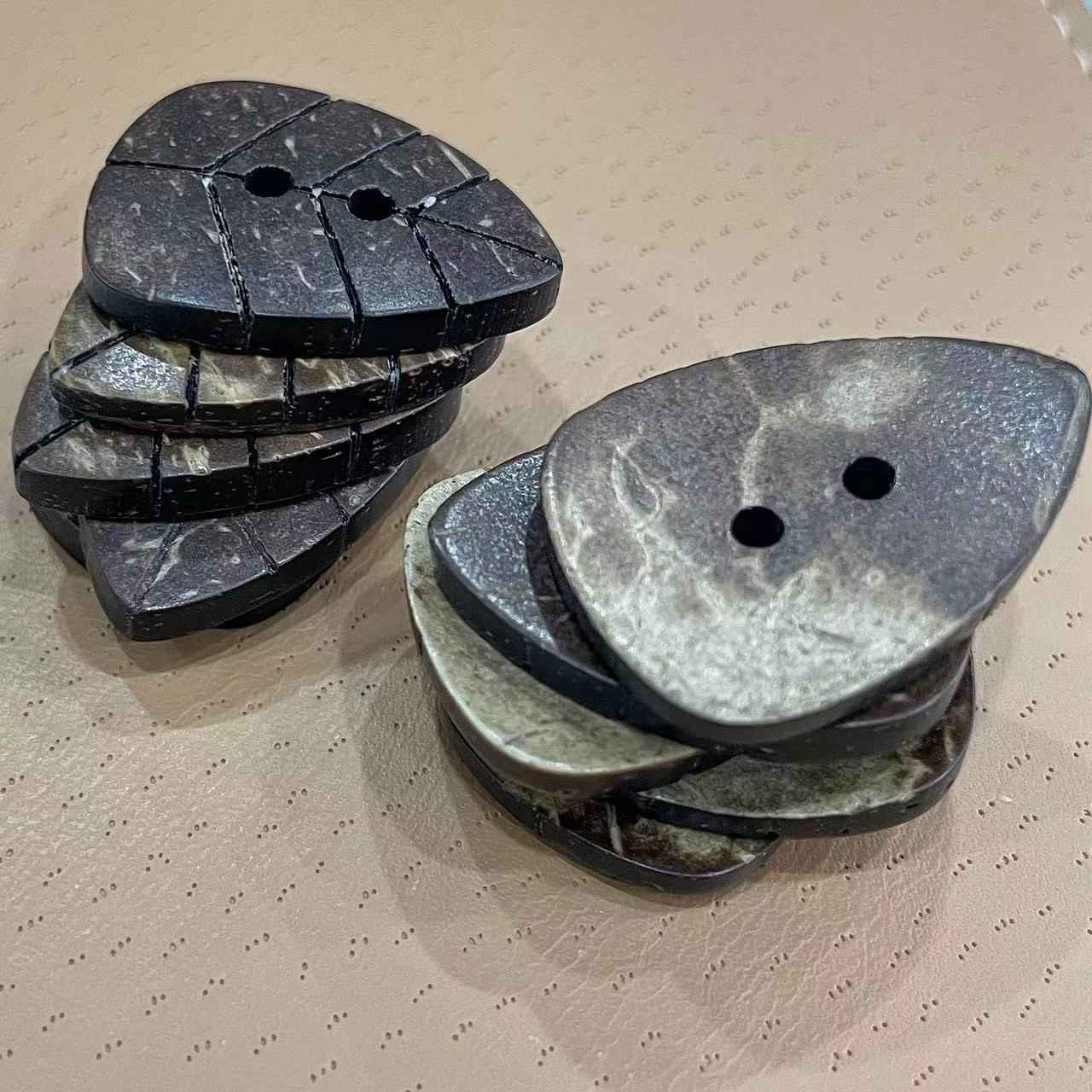 Natural coconut shell leaf buttons, two-hole leaf shapes stacked (side view)