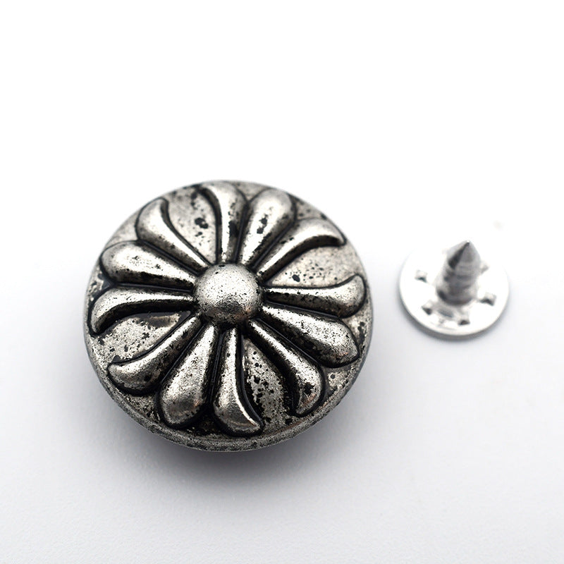 Round metal shank stud button with textured daisy flower sunburst design